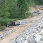 Progress on access road, headwall, with detention basin in background 06/11